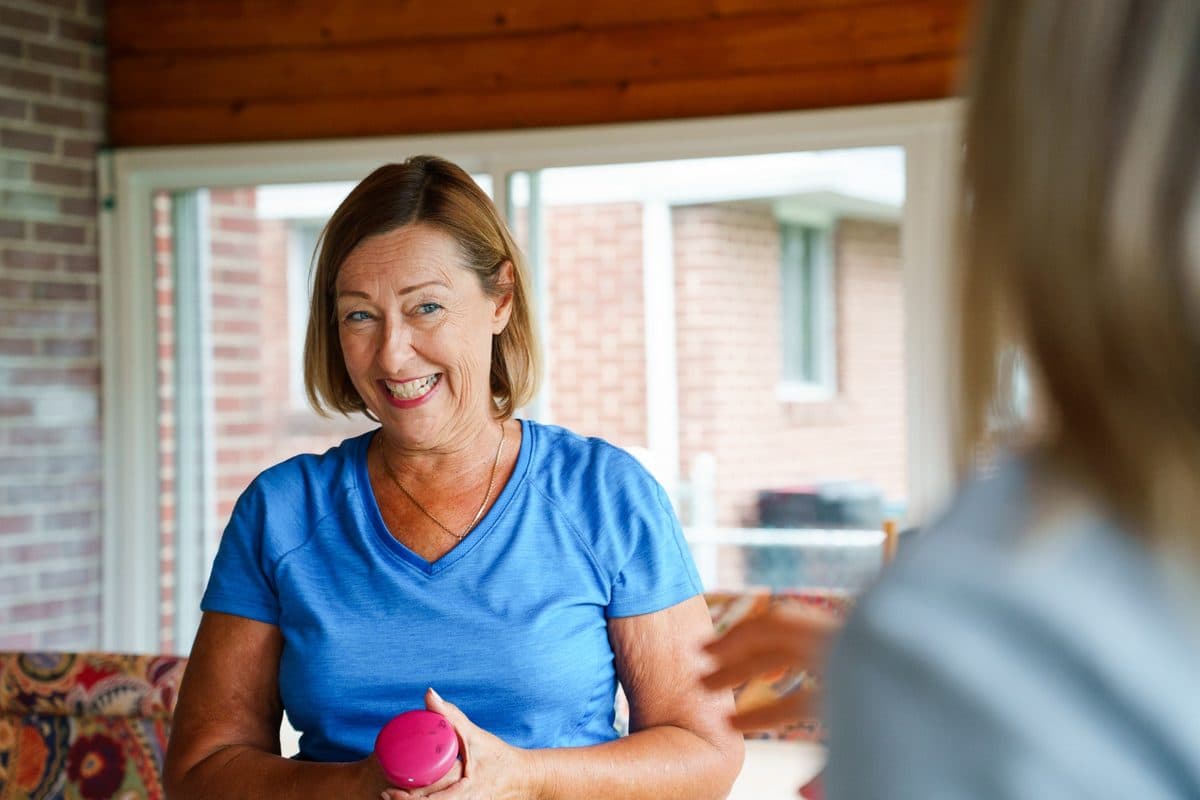 Smiling older adult during an at-home movement session.