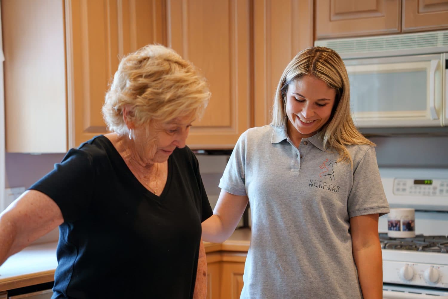 Nicole Ogletree coaching an adult through a home movement session.